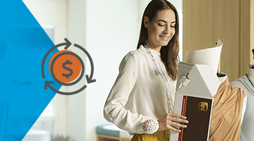 A woman in a light blouse holds an open delivery box with a clothing item inside, smiling. A circular money symbol icon is visible on a blue triangular overlay. There is a mannequin in the background.