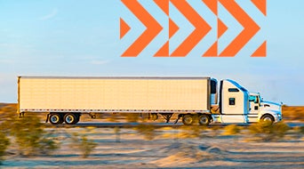 A white semi-truck with a long trailer driving on a desert road. The background shows blurred shrubs and sand, indicating motion. Orange geometric arrow patterns are overlaid at the top of the image.