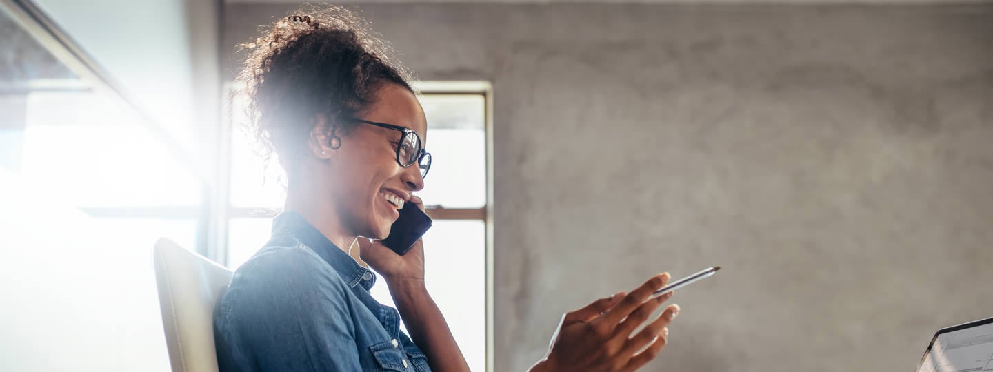 suggesting a bright idea.|A person with glasses sits at a desk