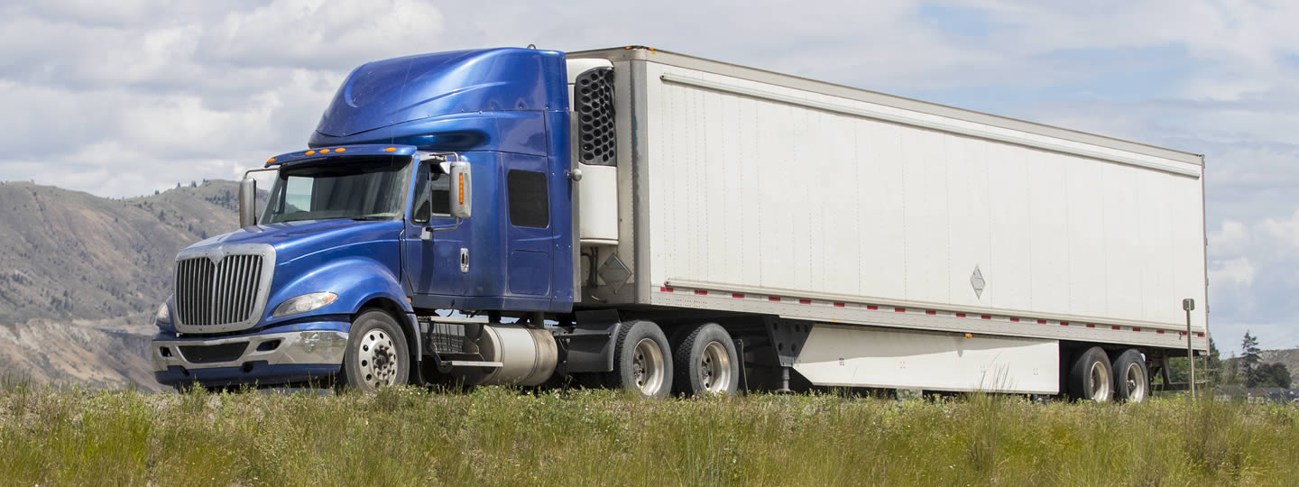 depicting a small-business-shipping-hub. The second truck from the left has open back doors showing stacked cardboard boxes