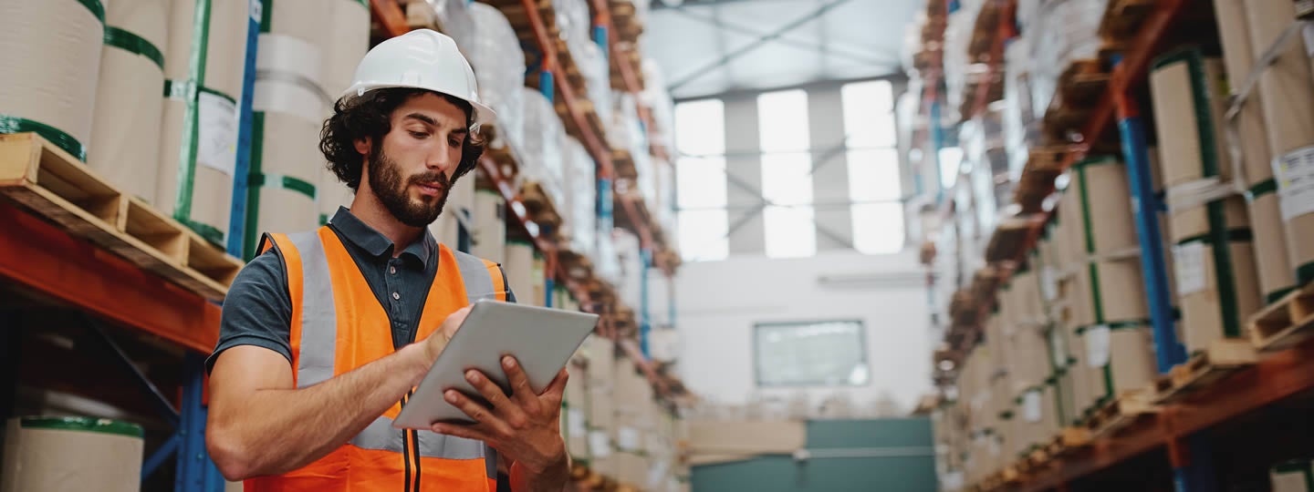 wearing a white hard hat and orange vest