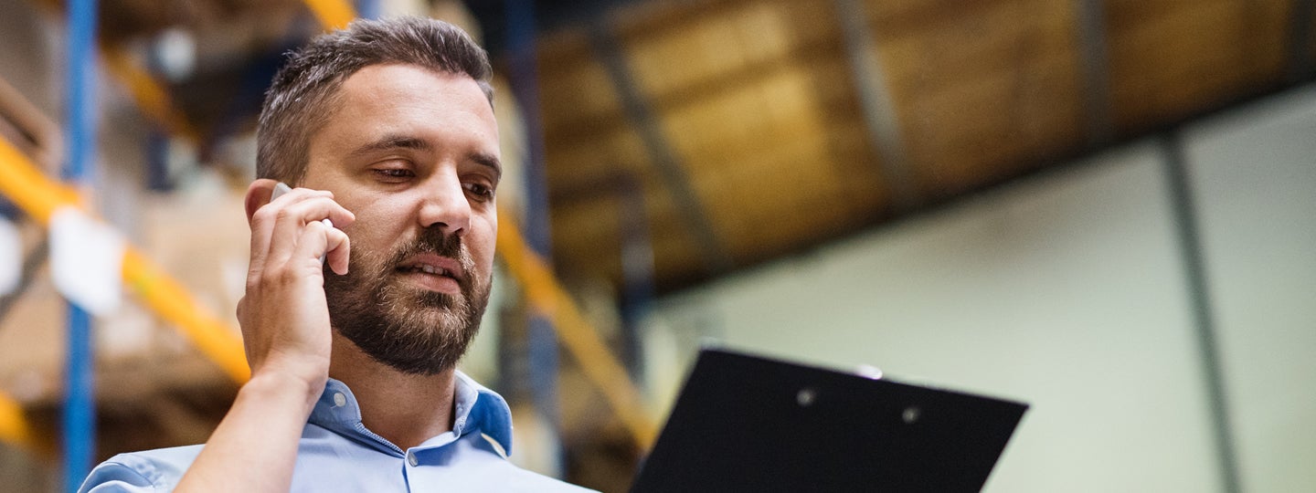 hinting at the warehouses lively operations.|A man with a beard