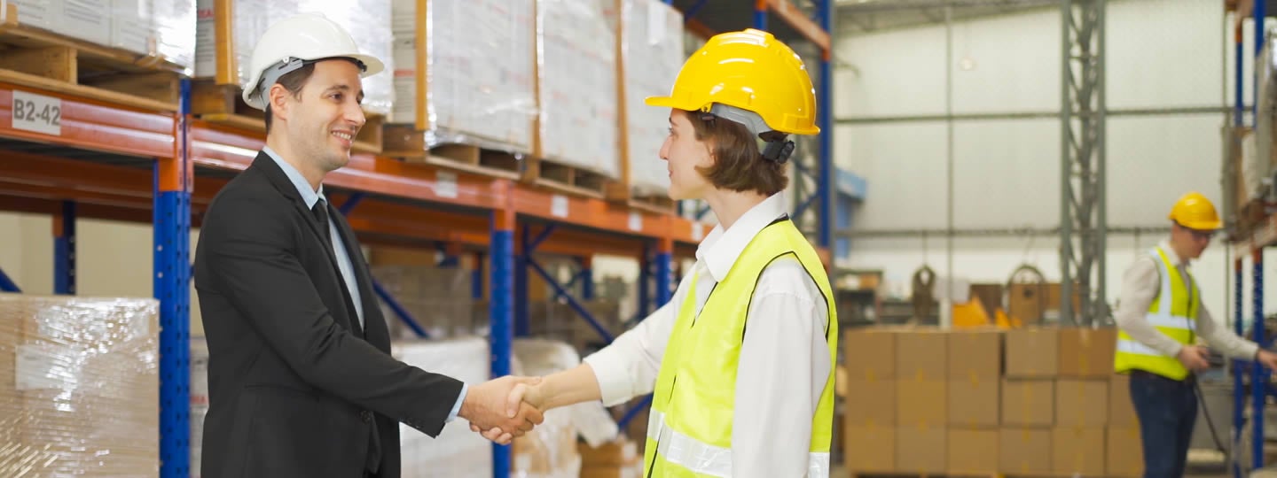 where shelves brim with boxes. Blue arrows guide the way for efficient freight shipping services in the background