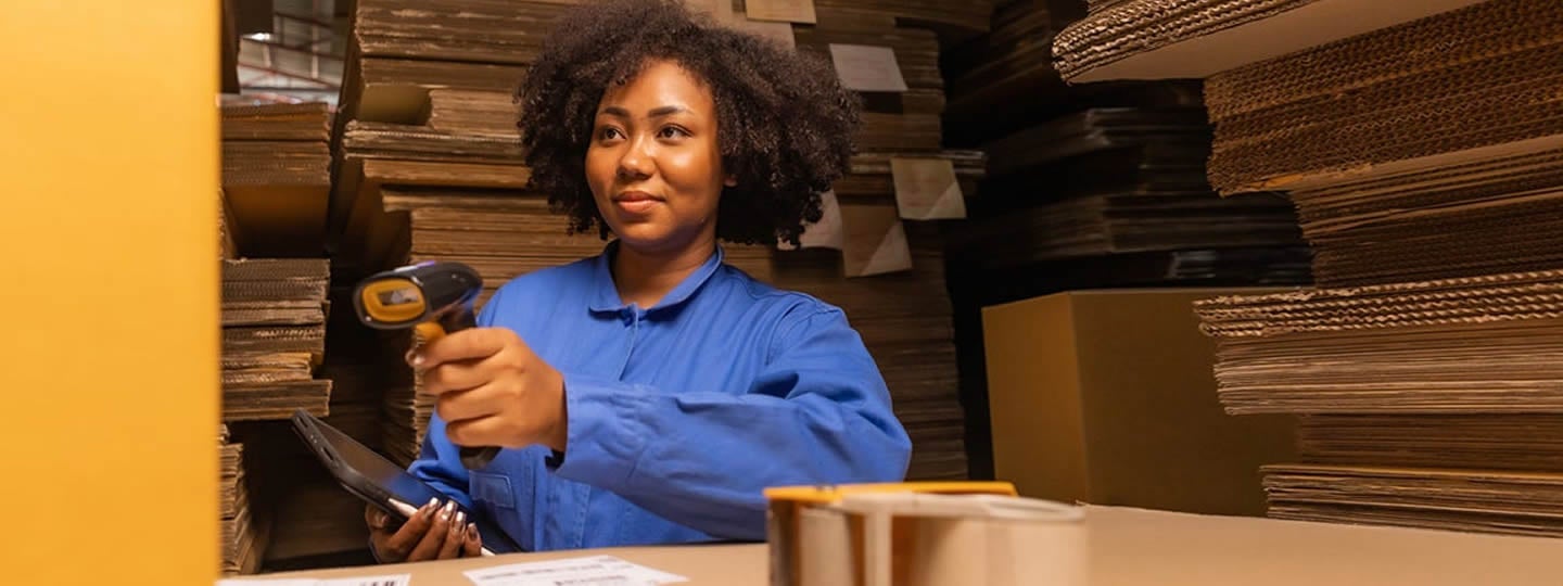 where Shipping With WWEX is streamlined. Amid stacks of cardboard boxes and with clipboard in hand