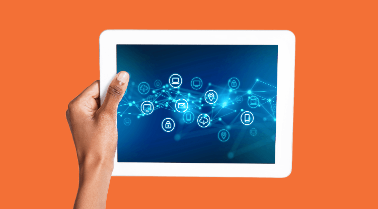 A hand holds a white tablet displaying digital network icons connected by lines on a blue background, symbolizing connectivity, technology, and the power of a supply chain control tower.