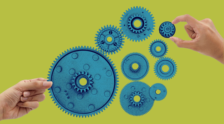 Two hands are holding blue gears against a gradient blue background, with several interlocking gears in the center, symbolizing teamwork and the coordination seen in a supply chain control tower.