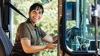 A delivery driver in a brown uniform