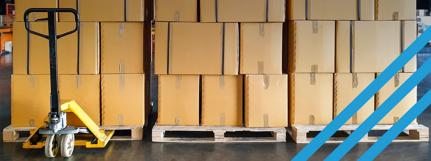 ready for Volume LTL shipping. A yellow pallet jack stands poised at the front