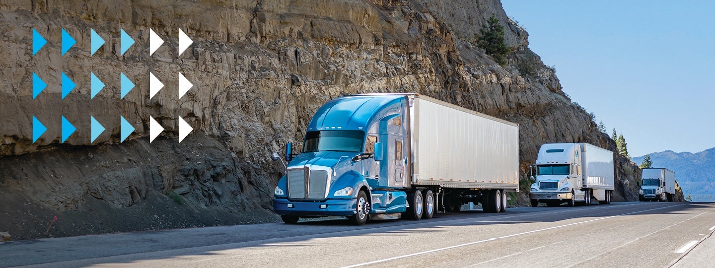 symbolizing the journey to a small-business-shipping-hub. Blue and white triangular shapes are overlaid on the left side of the image.|Three semi-trucks with trailers