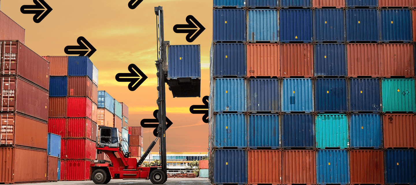 suggesting sunset.|A red forklift elevates a shipping container against a sunset backdrop