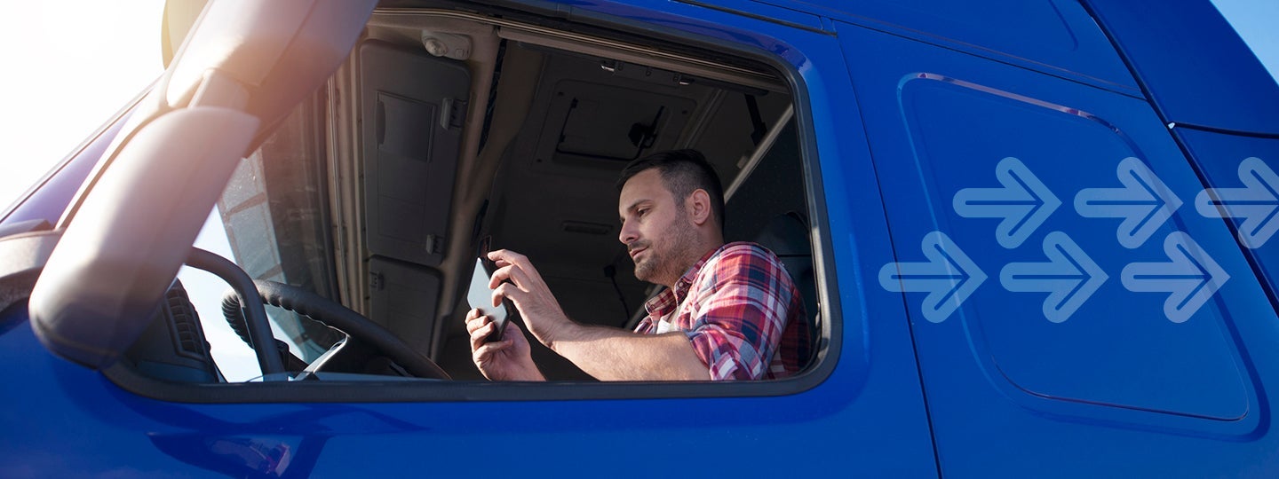holding a smartphone. The truck window is open