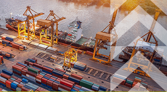 Aerial view of a busy shipping port at sunset