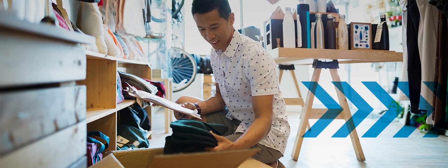 organizing clothes in a bustling small-business-shipping-hub. In the background