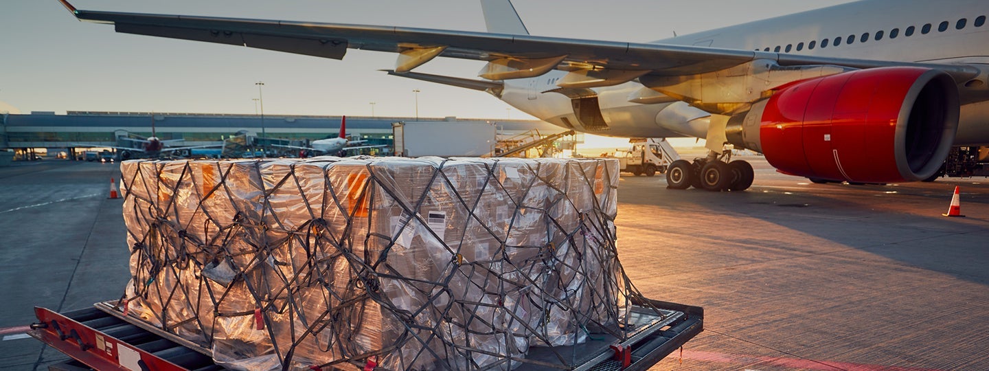 casting a warm glow over the airport scene.|A large cargo pallet