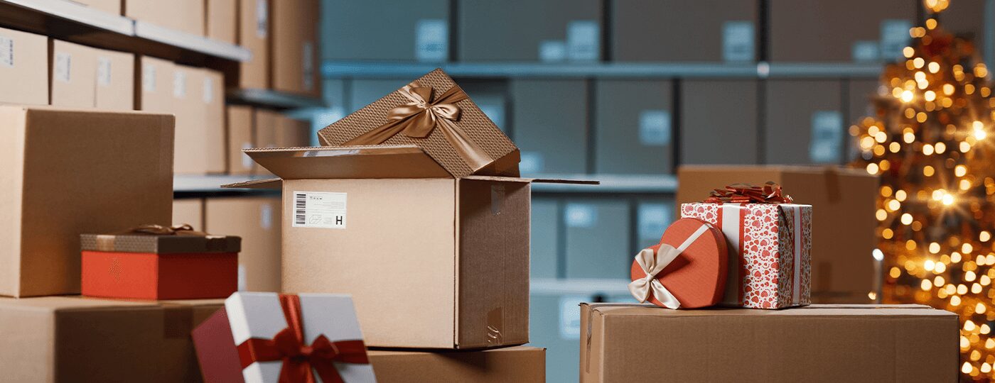 while the background shows shelves of plain boxes and a decorated Christmas tree.|A bustling warehouse scene unfolds with numerous cardboard boxes and gift-wrapped packages