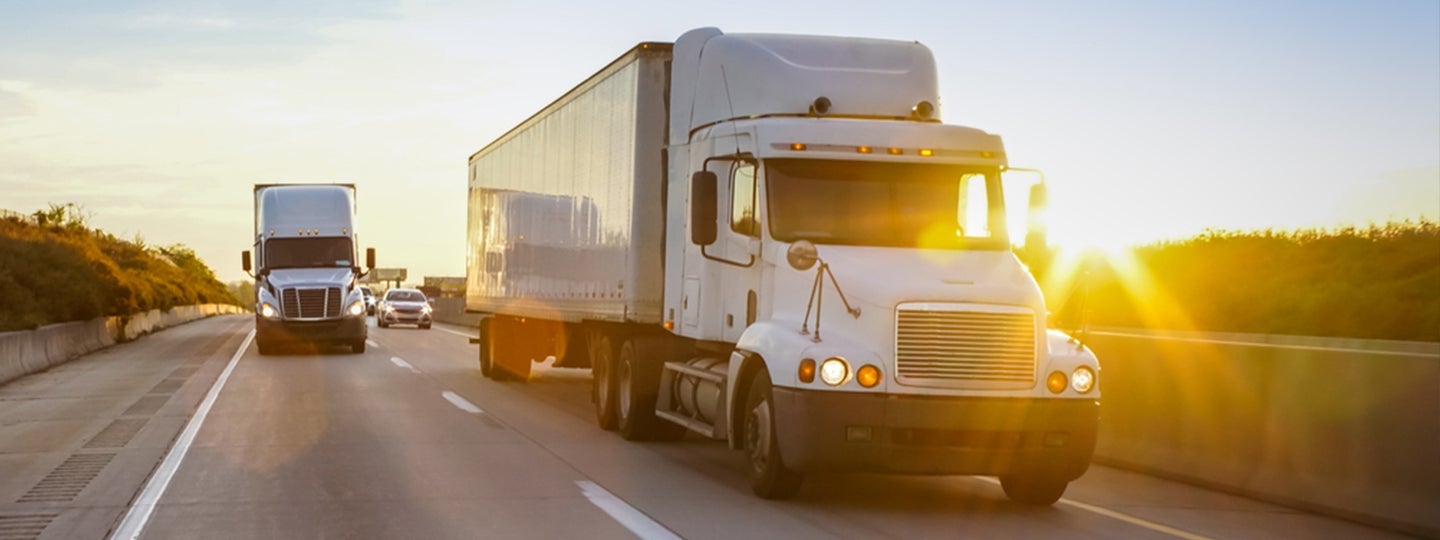 aiming to manage freight costs efficiently. The sun creates a bright glare