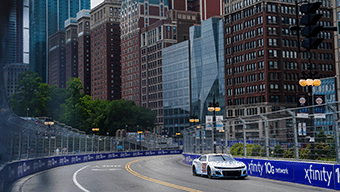 A race car speeds through the urban circuit of the WWEX NASCAR Chicago event