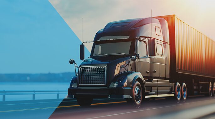A sleek black semi-truck with a container trailer travels on a highway near a body of water. The image has a split toning effect