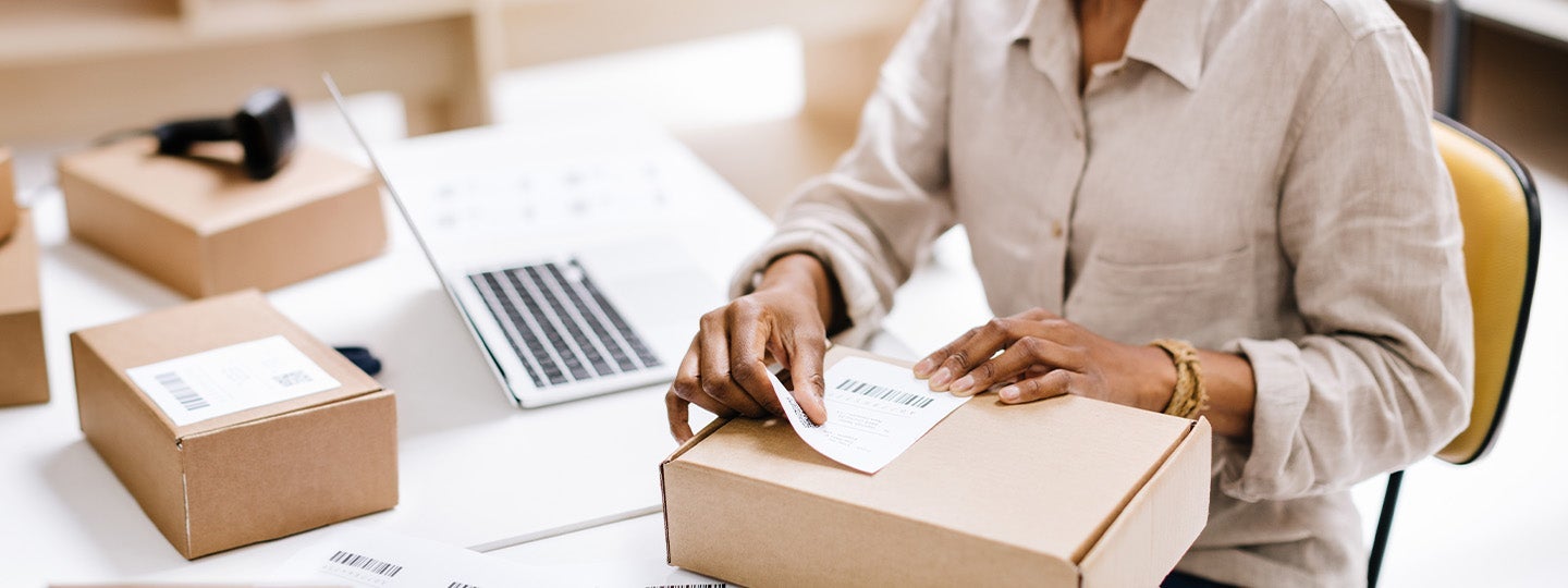 pointing to the right. A laptop is partially visible in the background.|A woman in a suit stands in an office holding a tablet