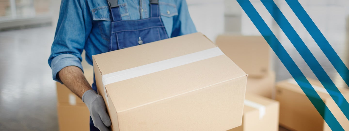 with more boxes and a blue diagonal stripe pattern in the background.|A person in a denim shirt and blue overalls is carefully holding a cardboard box