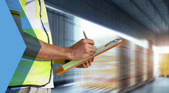 A person in a reflective vest writes on a clipboard