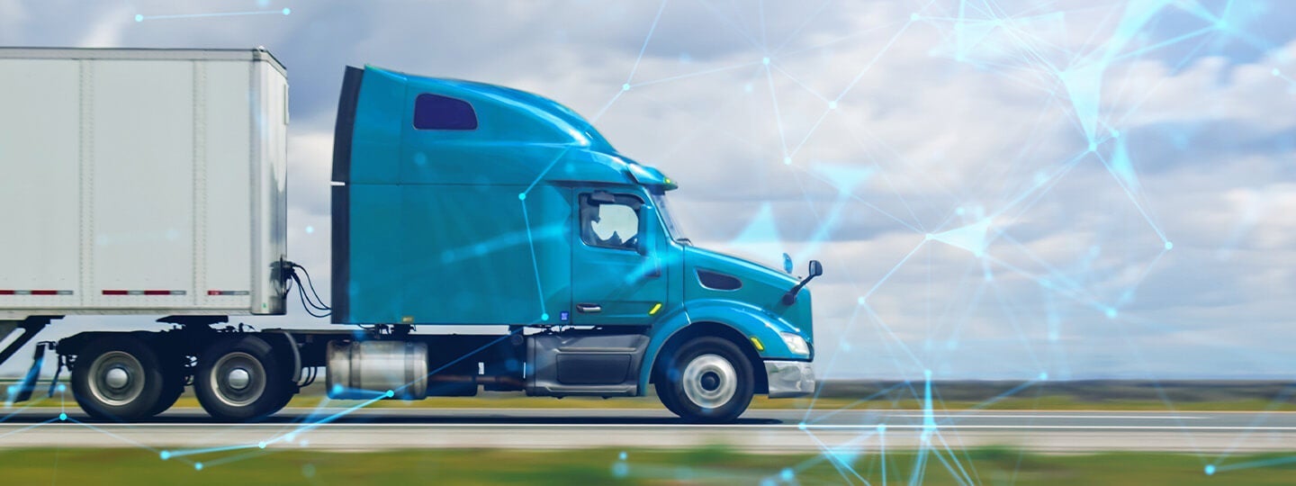 A bright blue semi-truck with a white trailer, representing Specialty Carriers, drives on a road with a digital network overlay and blurred landscape, highlighting the intersection of technology and specialty freight transportation.