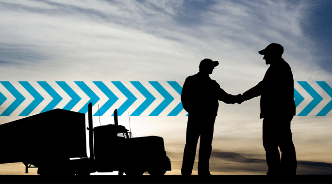 Silhouette of two people shaking hands near a truck at sunset, with blue chevron arrows in the background—perfectly capturing the partnership and trust in Specialty Freight services.