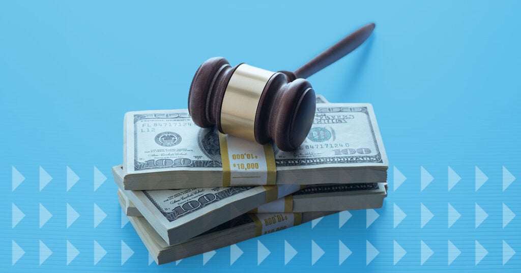 A judge’s gavel rests on top of three stacks of $100 bills, each bundle labeled $10,000—symbolizing a significant tariff refund—all set against a blue background with diagonal arrow patterns.
