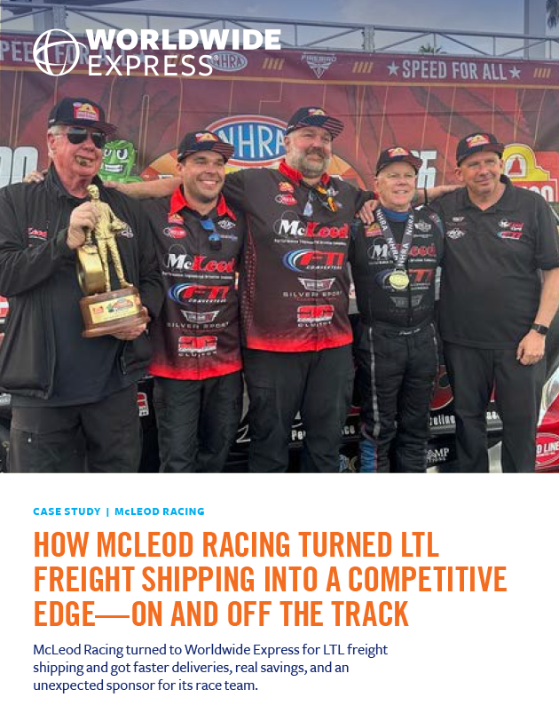 Four McLeod Racing team members, in matching black uniforms, stand smiling and holding awards in front of a branded backdrop at a racing event. A Worldwide Express logo appears above them, highlighting their valued partnership with the renowned 3PL provider supporting their manufacturing logistics operations.